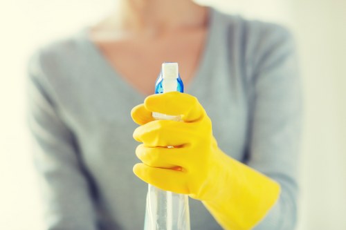 Technician handling cleaning products with care during deep clean