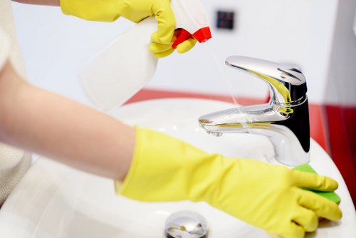 Deep cleaning staff member wearing PPE in a work area