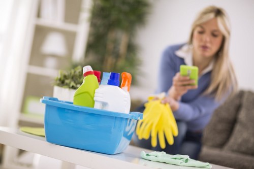 Local cleaner treating a fabric armchair in Wembley